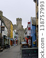 Medieval castle tower overlooking busy caernarfon street 138757993