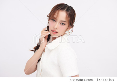 A beautiful young Asian woman with clean, fresh skin against a white background. Skincare, facial treatment, cosmetology, beauty, and spa. An elegant portrait of an Asian woman. A beautiful young Asian woman with clean, fresh skin against a white background. Skincare, facial treatment, cosmetology, beauty, and spa. An elegant portrait of an Asian woman. 138758105