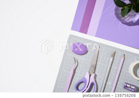 Purple craft supplies and paper sheets on white background with copy space. 138758208