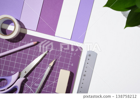 Creative workspace with purple hobby tools, paper, and cutting mat on white desk. Copyspace Creative workspace with purple hobby tools, paper, and cutting mat on white desk. Copyspace 138758212
