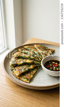 Stacked Korean Chive Pancake Slices with Soy Sauce Vertical Composition Stacked Korean Chive Pancake Slices with Soy Sauce Vertical Composition 138758238