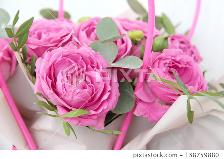 Close up of peony roses with green leaves in wrapping paper, a gift for a special occasion. Flower template for Mother's Day, weddings, birthdays, and Women's Day. Close up of peony roses with green leaves in wrapping paper, a gift for a special occasion. Flower template for Mother's Day, weddings, birthdays, and Women's Day. 138759880