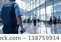 Security officer operates radio in busy business center with modern glass design 138759914