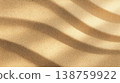 Sandy surface with wave-like ripples under soft sunlight and warm beige tones 138759922