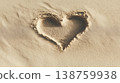 Heart shape drawn in sand at the beach during summer with soft light in a wide empty space 138759938