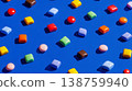 Multicolored chocolate candies spread on deep blue surface in playful arrangement 138759940