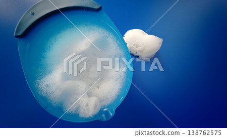 Bowl with soap foam on blue background while cleaning surfaces Bowl with soap foam on blue background while cleaning surfaces 138762575