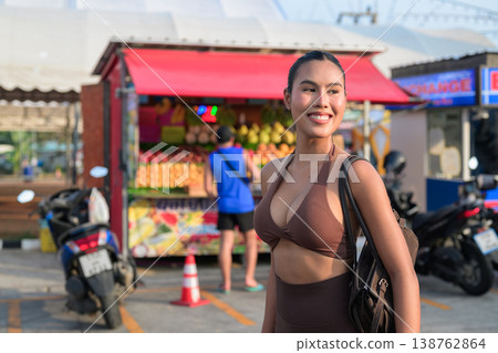 Young Woman in Brown Sports Bra at Sunny Outdoor Market Healthy Lifestyle Concept Young Woman in Brown Sports Bra at Sunny Outdoor Market Healthy Lifestyle Concept 138762864