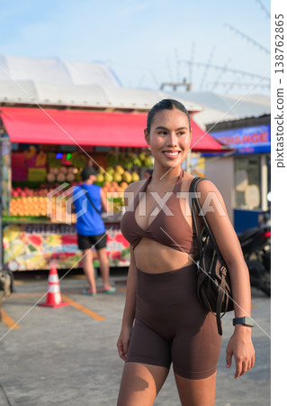 Smiling Thai Woman in Brown Activewear at Tropical Outdoor Market Healthy Lifestyle Concept Smiling Thai Woman in Brown Activewear at Tropical Outdoor Market Healthy Lifestyle Concept 138762865