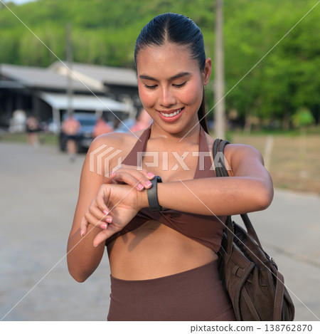 Thai Fitness Influencer Checking Smartwatch After Run Modern Digital Lifestyle Concept Thai Fitness Influencer Checking Smartwatch After Run Modern Digital Lifestyle Concept 138762870