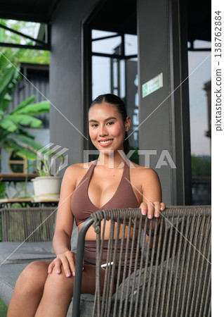 Portrait of Confident Thai Woman in Brown Yoga Wear at Outdoor Cafe Gym Training Done Concept Portrait of Confident Thai Woman in Brown Yoga Wear at Outdoor Cafe Gym Training Done Concept 138762884