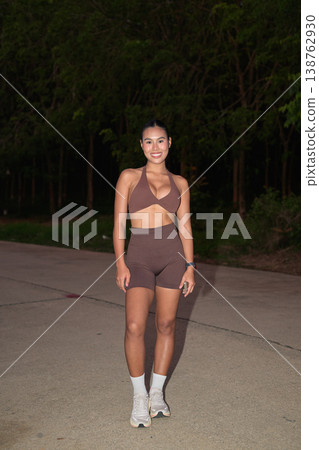 Full Body Portrait of Smiling Thai Fitness Influencer at Night Modern Wellness Concept 138762930