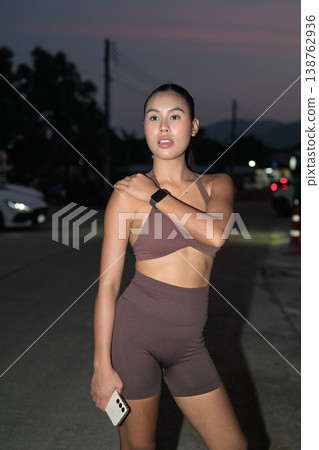 Fit Thai Fitness Influencer Stretching at Dusk Modern Outdoor Wellness Concept Fit Thai Fitness Influencer Stretching at Dusk Modern Outdoor Wellness Concept 138762936