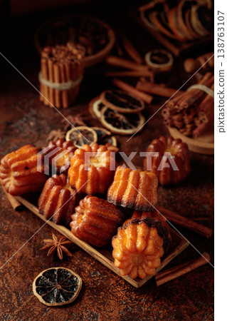 Cinnamon cakes in wooden dish on a brown background. Cinnamon cakes in wooden dish on a brown background. 138763107