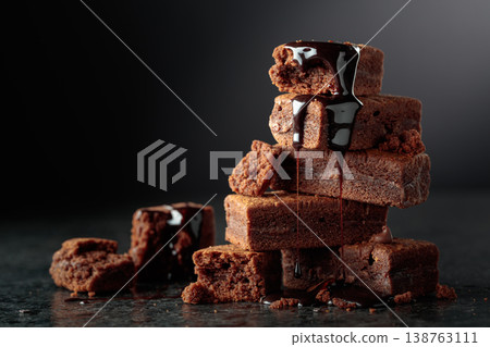 Brownie pieces on a black background. 138763111