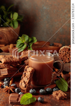 Brownie, mug of chocolate drink, fresh blueberries and mint. 138763114