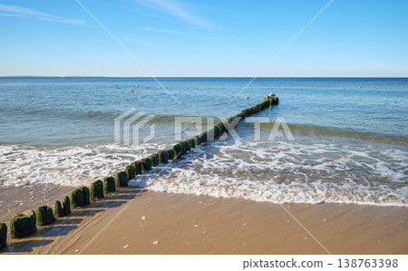 Old wooden breakwater on the beach. Old wooden breakwater on the beach. 138763398
