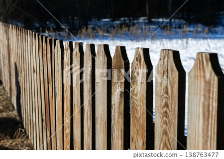 Rustic snowy boundary. Aged timber boundary stretching across snowcovered rural landscape Rustic snowy boundary. Aged timber boundary stretching across snowcovered rural landscape 138763477
