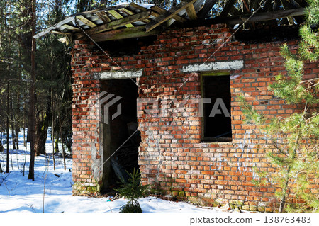 Frozen structure amid pine trees. Silent winter landscape with aged masonry and surrounding pines Frozen structure amid pine trees. Silent winter landscape with aged masonry and surrounding pines 138763483