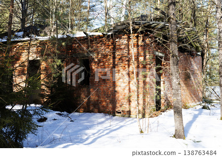 Abandoned frostcovered brick structure. Winter forest surrounding aging brick building Abandoned frostcovered brick structure. Winter forest surrounding aging brick building 138763484