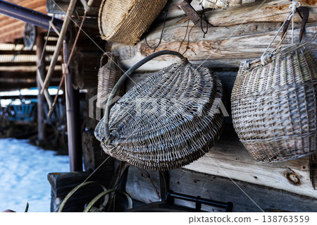 Traditional woven baskets arranged on aged wooden surface with snowdusted surroundings 138763559
