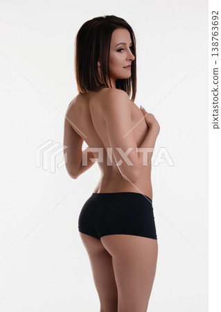 Topless brunette in black panties, seductive back pose Topless brunette in black panties, seductive back pose 138763692
