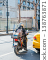 Fastmoving Motorcycle Courier Navigates Bustling City Streets With Urgency And Purpose 138763871