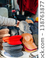 Stylish Headgear On Street Scene. Market Display Features Diverse Caps And Berets In Bold Hues 138763877