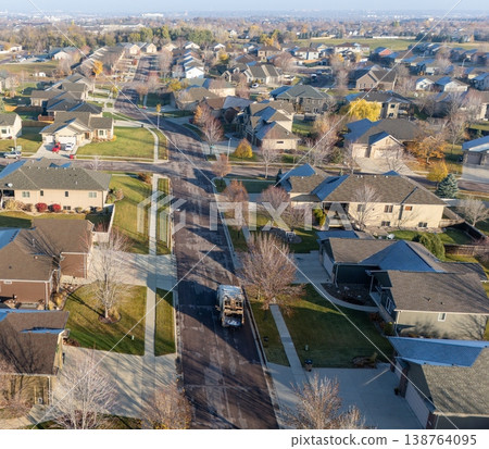 aerial view of a garbage truck going down a residential area in the morning aerial view of a garbage truck going down a residential area in the morning 138764095