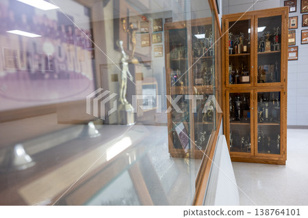 Trophy display showing sports achievements in a hall with glass cabinets for memorabilia Trophy display showing sports achievements in a hall with glass cabinets for memorabilia 138764101
