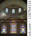 Ornate historical mosque dome interior with multiple stained glass windows 138764133
