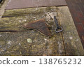 Rusty key and old metal tool on weathered wooden table with moss and stains 138765232