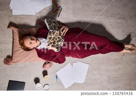 White woman fashion editor planning with patterned notebook 138765416