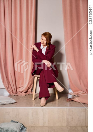 Sophisticated redheaded consultant radiates assurance in simple setting Sophisticated redheaded consultant radiates assurance in simple setting 138765444