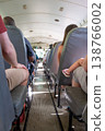 Interior view of an empty bus with passengers seated during a sunny day trip 138766002