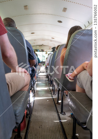 Interior view of an empty bus with passengers seated during a sunny day trip Interior view of an empty bus with passengers seated during a sunny day trip 138766002