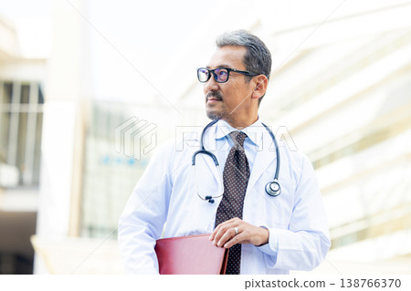 A man wearing a white suit A man wearing a white suit 138766370