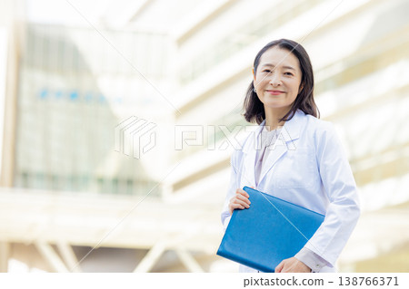 Smiling woman in a white coat Smiling woman in a white coat 138766371