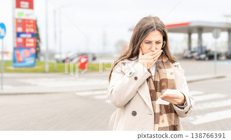 Fuel inflation concept woman shocked by gas receipt Fuel inflation concept woman shocked by gas receipt 138766391