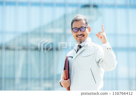 A man wearing work clothes 138766412
