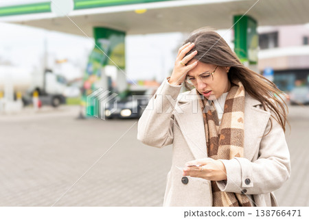 Fuel inflation concept woman shocked by gas receipt 138766471