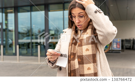 Young Woman Reacting to High Cost Grocery Receipt Young Woman Reacting to High Cost Grocery Receipt 138766472