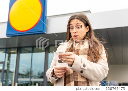 Young Woman Reacting to High Cost Grocery Receipt 138766475