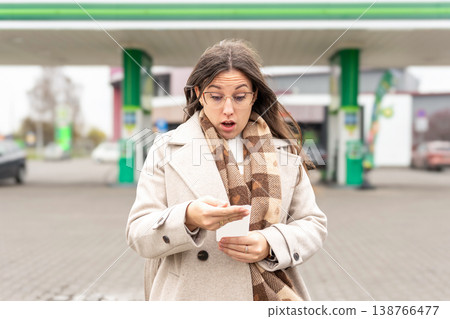 Fuel inflation concept woman shocked by gas receipt 138766477