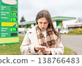 Budget stress young woman calculating petrol costs 138766483