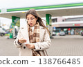 Budget stress young woman calculating petrol costs 138766485