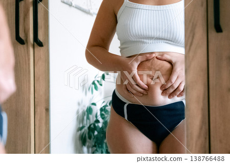 Plus size woman. Real female body indoors. Body neutrality conce Plus size woman. Real female body indoors. Body neutrality conce 138766488