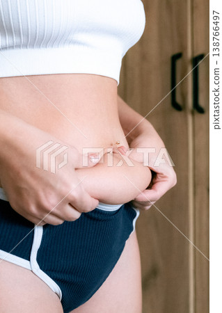 Curvy woman. Natural belly fat close up. Body acceptance concept Curvy woman. Natural belly fat close up. Body acceptance concept 138766497