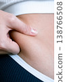 Woman overweight body. Female touching stomach near mirror. Weig 138766508