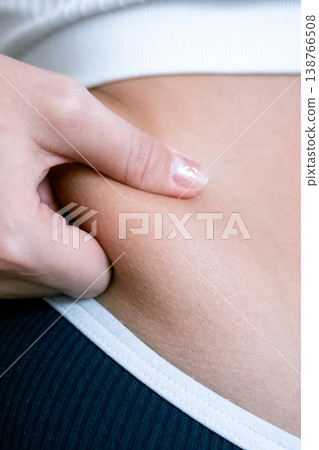 Woman overweight body. Female touching stomach near mirror. Weig Woman overweight body. Female touching stomach near mirror. Weig 138766508